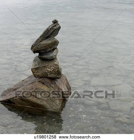 Stack of stones in the Yamdrok Lake, Nagarze, Shannan, Tibet, China View Large Photo Image Stock Photo - Stack of stones in the Yamdrok Lake, Nagarze, Shannan, Tibet, China. Fotosearch