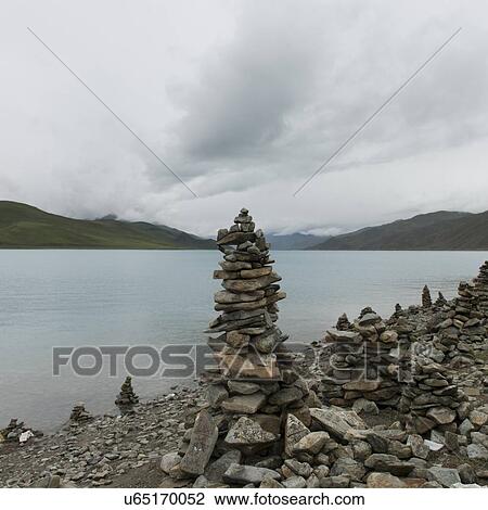 Stock Image - Stacks of stones at the lakeside, Yamdrok Lake, Nagarze, Shannan, Tibet, China. Fotosearch