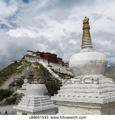 Stock Image - Stupas with Potala Palace in the background, Lhasa, Tibet, China. Fotosearch