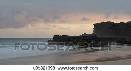 Stock Photo - Surf on the beach at sunset, Sandy Beach, Hawaii Kai, Honolulu, Oahu, Hawaii, USA. Fotosearch