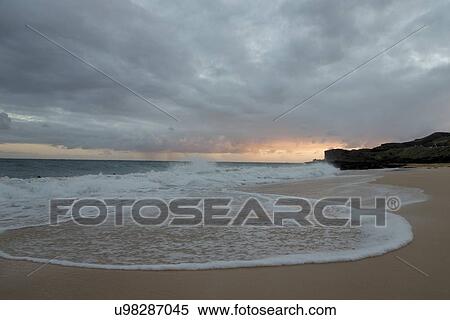 Stock Photography - Surf on the beach at sunset, Sandy Beach, Hawaii Kai, Honolulu, Oahu, Hawaii, USA. Fotosearch