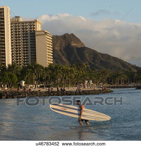 Surfer on the beach with Diamond Head in background, Waikiki, Honolulu, Oahu, Hawaii, USA View Large Photo Image Stock Image - Surfer on the beach with Diamond Head in background, Waikiki, Honolulu, Oahu, Hawaii, USA. Fotosearch