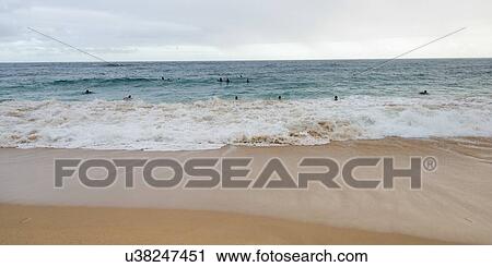 Stock Image - Surfers on the beach, Sandy Beach, Hawaii Kai, Honolulu, Oahu, Hawaii, USA. Fotosearch