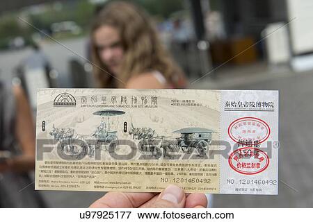 Stock Photo - Tourist holding the entry pass of Emperor Qin Shin Huang's Mausoleum site Museum, Xi'an, Shaanxi, China.. Fotosearch