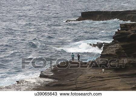 Stock Image - Tourists on the seashore, Hawaii Kai, Honolulu, Oahu, Hawaii, USA. Fotosearch