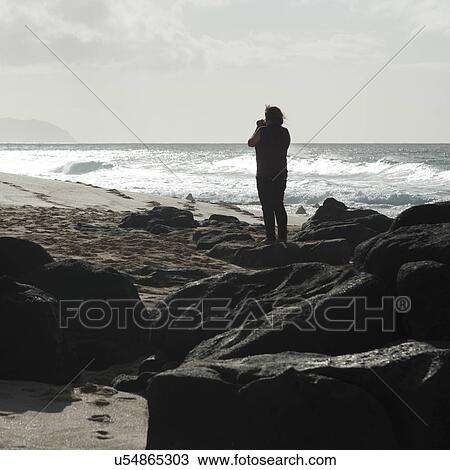 Woman photographing on the beach, Haleiwa, North Shore, Oahu, Hawaii, USA View Large Photo Image Stock Image - Woman photographing on the beach, Haleiwa, North Shore, Oahu, Hawaii, USA. Fotosearch