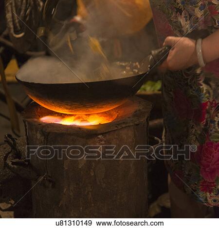 Woman's hand cooking food in a wok. View Large Photo Image Stock Photo - Woman's hand cooking food in a wok.. Fotosearch