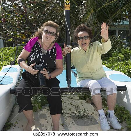 Stock Photo - Women sitting on a catamaran and smiling, Kailua Beach, Kailua, Oahu, Hawaii, USA. Fotosearch