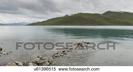 Yamdrok Lake with mountains in the background, Nagarze, Shannan, Tibet, China View Large Photo Image Stock Photography - Yamdrok Lake with mountains in the background, Nagarze, Shannan, Tibet, China. Fotosearch