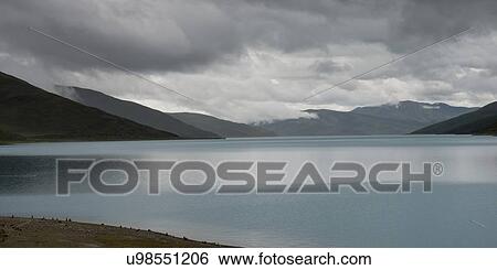 Yamdrok Lake with mountains under cloudy sky, Nagarze, Shannan, Tibet, China View Large Photo Image Stock Photograph - Yamdrok Lake with mountains under cloudy sky, Nagarze, Shannan, Tibet, China. Fotosearch