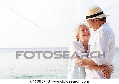Stock Image - Affectionate Senior Couple On Tropical Beach Holiday. Fotosearch