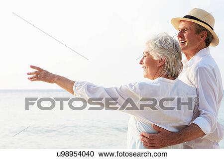 Stock Image - Affectionate Senior Couple On Tropical Beach Holiday. Fotosearch