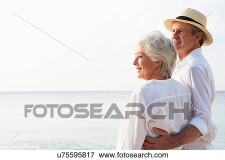 Stock Photo - Affectionate Senior Couple On Tropical Beach Holiday. Fotosearch
