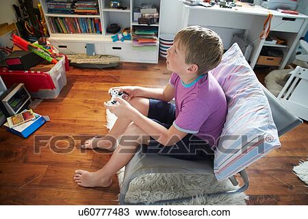 Boy Holding Controller Playing Video Game View Large Photo Image Stock Image - Boy Holding Controller Playing Video Game. Fotosearch