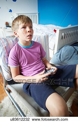 Boy Holding Controller Playing Video Game View Large Photo Image Stock Image - Boy Holding Controller Playing Video Game. Fotosearch