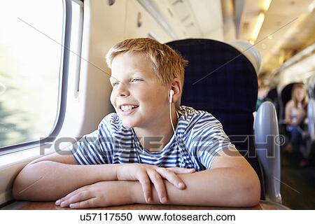 Boy Listening To Music On Train Journey View Large Photo Image Stock Image - Boy Listening To Music On Train Journey. Fotosearch