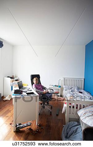 Stock Image - Boy Playing Video Game In Bedroom. Fotosearch