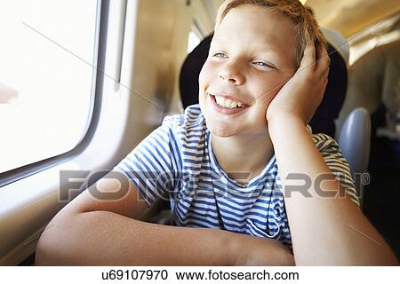 Boy Relaxing On Train Journey View Large Photo Image Stock Image - Boy Relaxing On Train Journey. Fotosearch