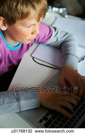 Boy Studying In Bedroom Using Laptop View Large Photo Image Stock Image - Boy Studying In Bedroom Using Laptop. Fotosearch