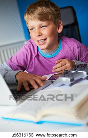 Boy Studying In Bedroom Using Laptop View Large Photo Image Stock Image - Boy Studying In Bedroom Using Laptop. Fotosearch