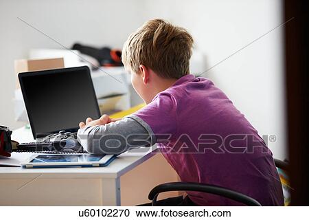 Boy Using Laptop In Bedroom View Large Photo Image Stock Image - Boy Using Laptop In Bedroom. Fotosearch