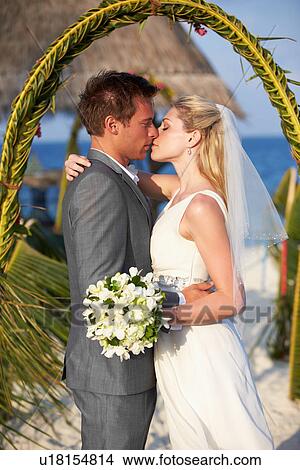 Picture - Bride And Groom Getting Married In Beach Ceremony. Fotosearch