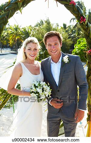Picture - Bride And Groom Getting Married In Beach Ceremony. Fotosearch
