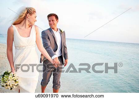 Stock Image - Bride And Groom Getting Married In Beach Ceremony. Fotosearch