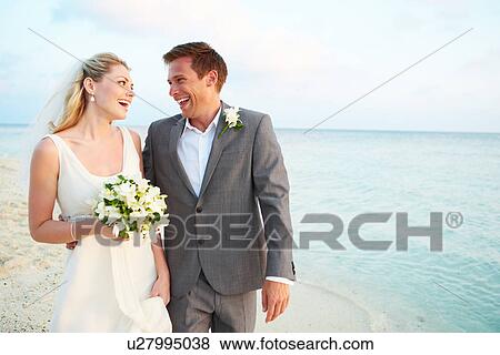 Bride And Groom Getting Married In Beach Ceremony View Large Photo Image Stock Photo - Bride And Groom Getting Married In Beach Ceremony. Fotosearch