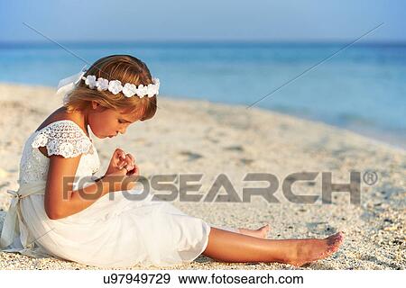 Stock Photo - Bridesmaid Sitting On Beach At Wedding Ceremony. Fotosearch