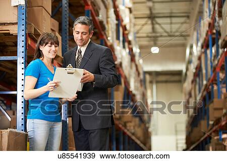 Businessman And Female Worker In Distribution Warehouse View Large Photo Image Stock Photo - Businessman And Female Worker In Distribution Warehouse. Fotosearch