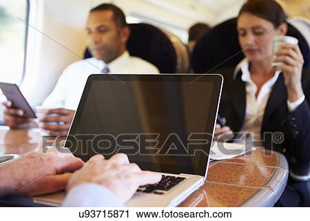 Businessman Commuting To Work On Train And Using Laptop View Large Photo Image Stock Image - Businessman Commuting To Work On Train And Using Laptop. Fotosearch