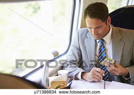 Businessman Eating Sandwich On Train Journey View Large Photo Image Picture - Businessman Eating Sandwich On Train Journey. Fotosearch