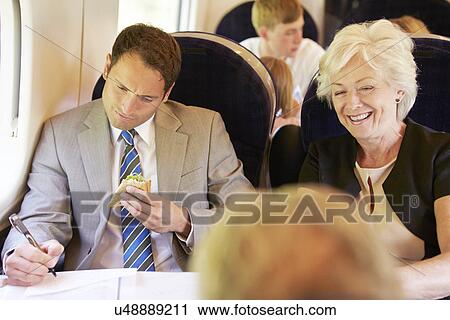 Businessman Eating Sandwich On Train Journey View Large Photo Image Stock Image - Businessman Eating Sandwich On Train Journey. Fotosearch