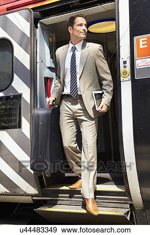 Businessman Getting Off Train At Platform View Large Photo Image Stock Photo - Businessman Getting Off Train At Platform. Fotosearch