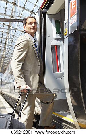Businessman Getting On Train At Platform View Large Photo Image Stock Image - Businessman Getting On Train At Platform. Fotosearch