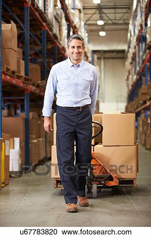 Businessman Pulling Pallet In Warehouse View Large Photo Image Stock Image - Businessman Pulling Pallet In Warehouse. Fotosearch