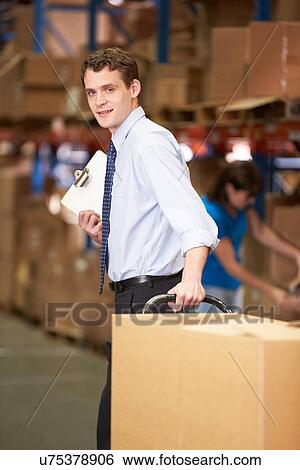Businessman Pulling Pallet In Warehouse View Large Photo Image Stock Photograph - Businessman Pulling Pallet In Warehouse. Fotosearch
