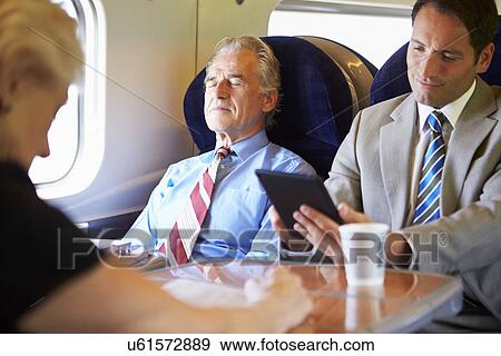 Stock Photo - Businessman Resting On Train Journey. Fotosearch
