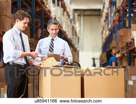 Stock Photograph - Businessmen Checking Boxes With Digital Tablet And Scanner. Fotosearch