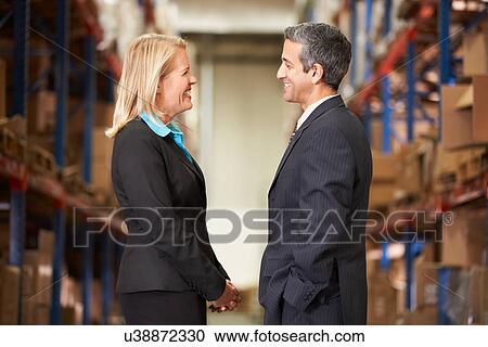Businesswoman And Businessman In Distribution Warehouse View Large Photo Image Stock Image - Businesswoman And Businessman In Distribution Warehouse. Fotosearch