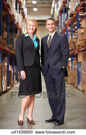 Businesswoman And Businessman In Distribution Warehouse View Large Photo Image Stock Image - Businesswoman And Businessman In Distribution Warehouse. Fotosearch