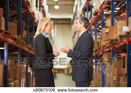 Businesswoman And Businessman In Distribution Warehouse View Large Photo Image Stock Photograph - Businesswoman And Businessman In Distribution Warehouse. Fotosearch