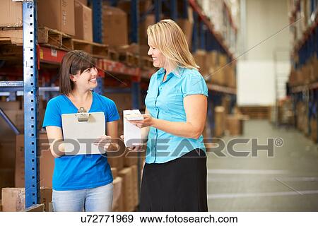 Businesswoman And Female Worker In Distribution Warehouse View Large Photo Image Stock Photo - Businesswoman And Female Worker In Distribution Warehouse. Fotosearch