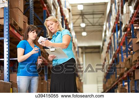 Businesswoman And Female Worker In Distribution Warehouse View Large Photo Image Stock Photography - Businesswoman And Female Worker In Distribution Warehouse. Fotosearch