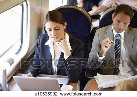 Businesswoman Commuting To Work On Train And Using Laptop View Large Photo Image Stock Image - Businesswoman Commuting To Work On Train And Using Laptop. Fotosearch