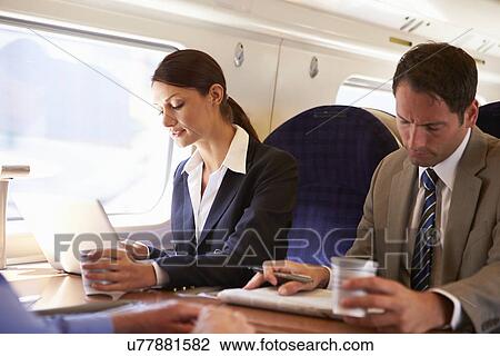 Businesswoman Commuting To Work On Train And Using Laptop View Large Photo Image Stock Image - Businesswoman Commuting To Work On Train And Using Laptop. Fotosearch