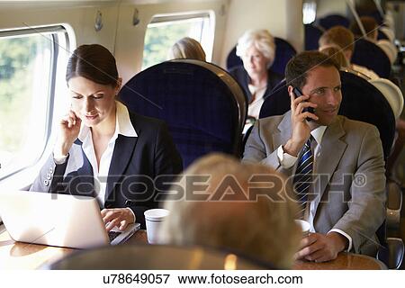 Businesswoman Commuting To Work On Train And Using Laptop View Large Photo Image Stock Photo - Businesswoman Commuting To Work On Train And Using Laptop. Fotosearch