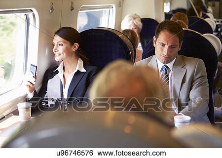 Businesswoman Commuting To Work On Train Using Mobile Phone View Large Photo Image Stock Photograph - Businesswoman Commuting To Work On Train Using Mobile Phone. Fotosearch