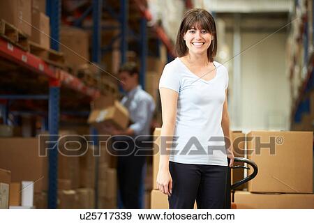 Businesswoman Pulling Pallet In Warehouse View Large Photo Image Stock Photo - Businesswoman Pulling Pallet In Warehouse. Fotosearch
